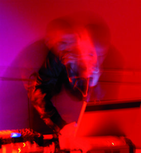 強烈なレッドライトで照らされたライブの瞬間を捉えた写真